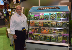 Charlie Eagle from Southern Specialties next to the cooler with all specialty items, imported and locally sourced